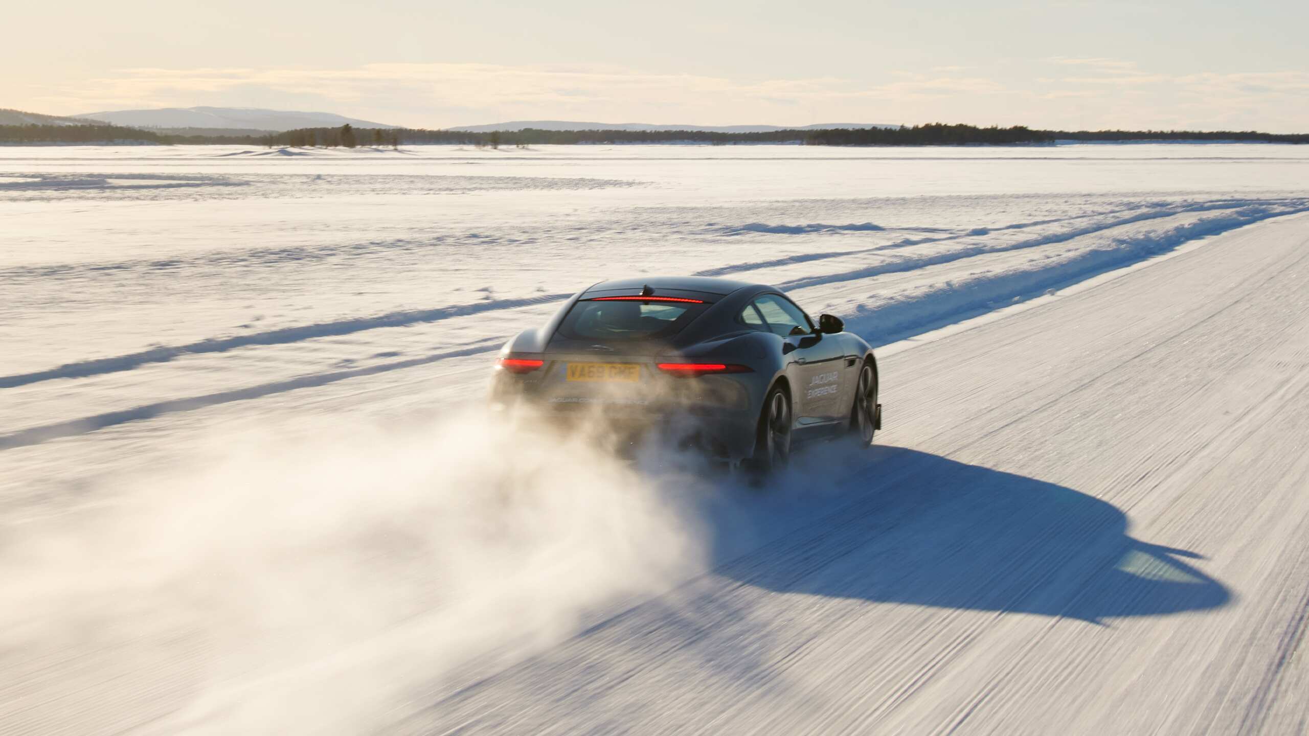 Jaguar FTYPE passes through a snowdrift and snowy land road